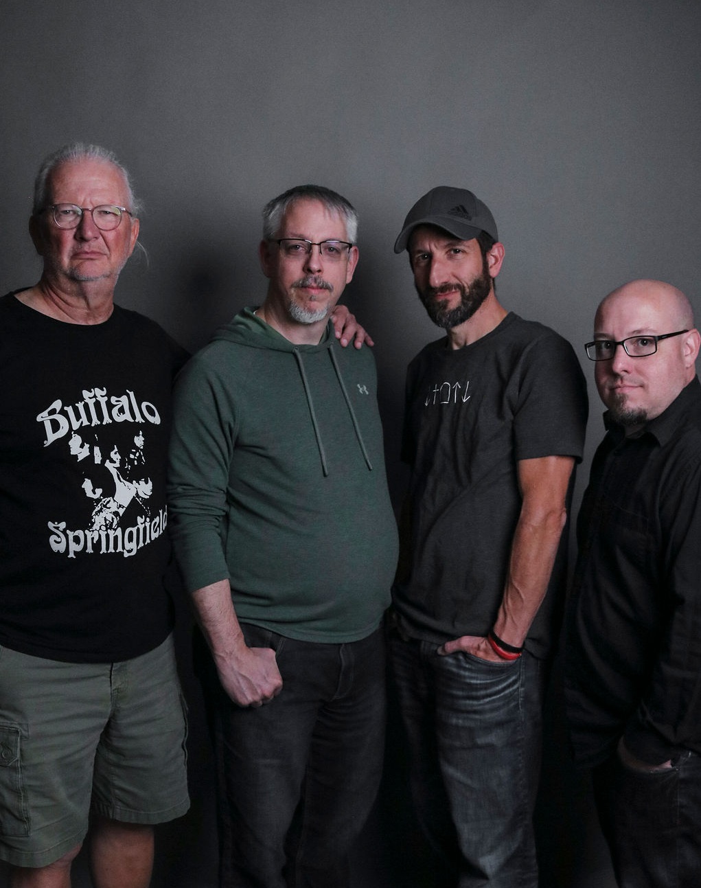 A group picture of the band without their instruments