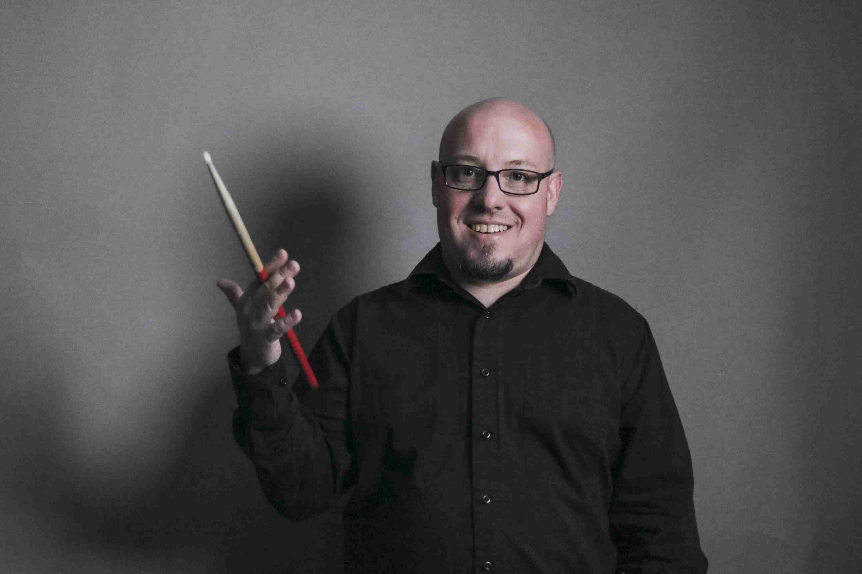 Kyle Herman twirling a drumstick