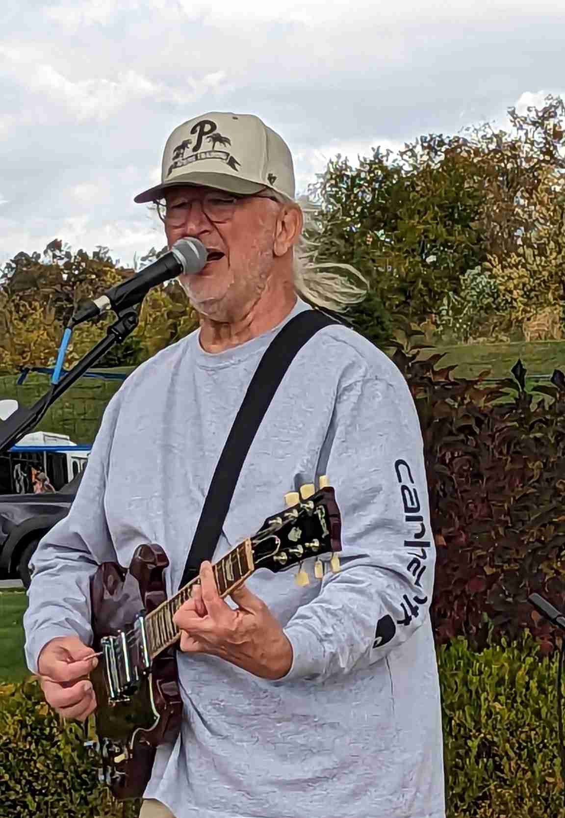 Gary Harmon playing guitar and singing