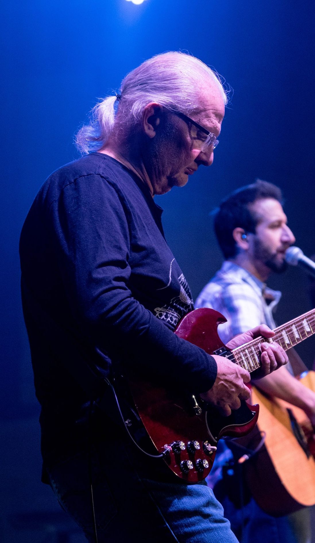 Gary Harmon playing guitar with Jon Pacella singing in the background