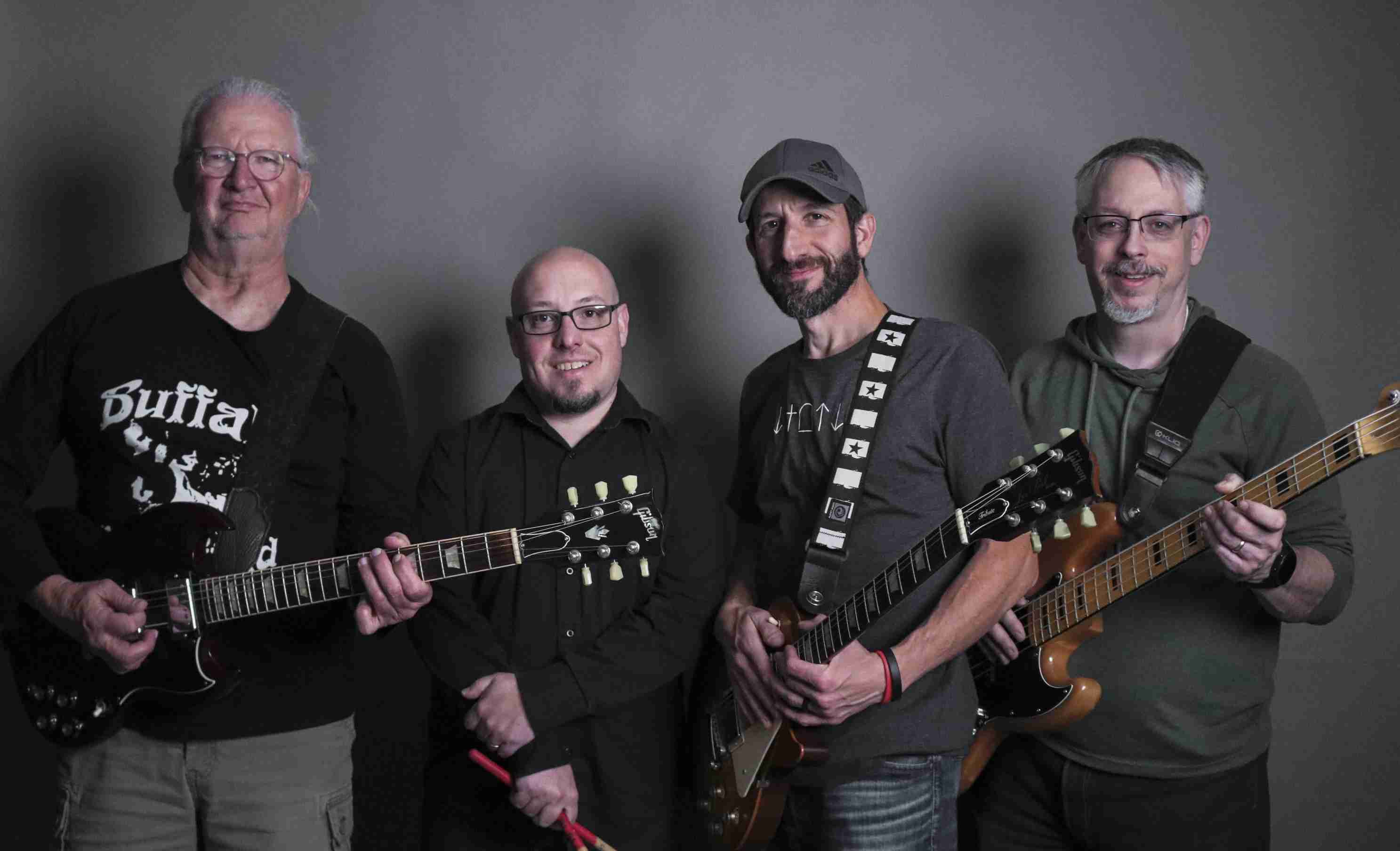A professional picture of the band holding their instruments