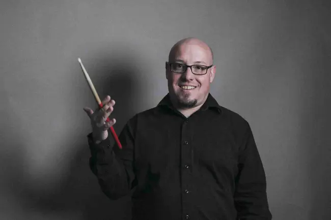 Kyle Herman twirling a drumstick