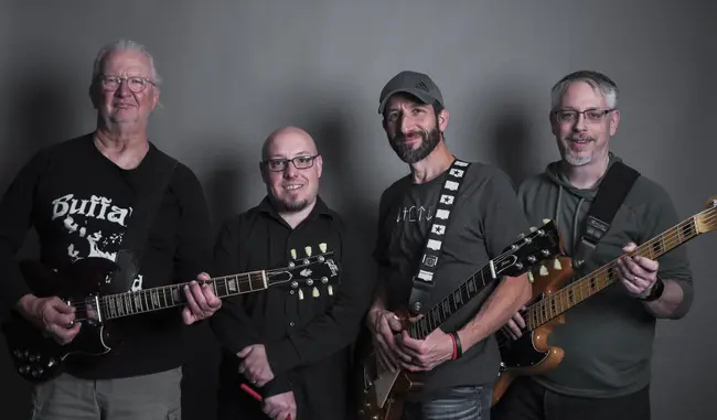 A professional picture of the band holding their instruments